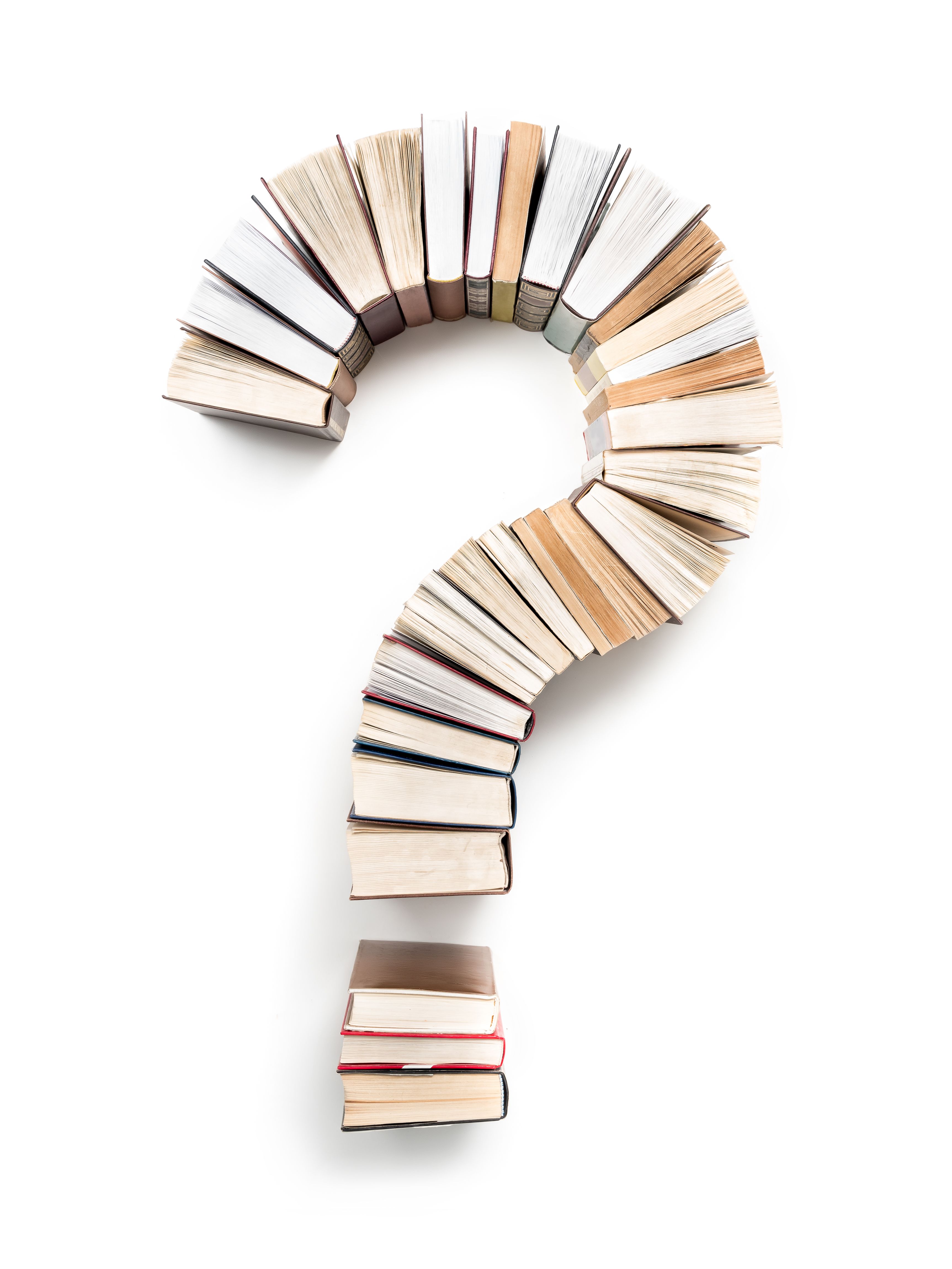 Piles of books presented in the shape of a question mark