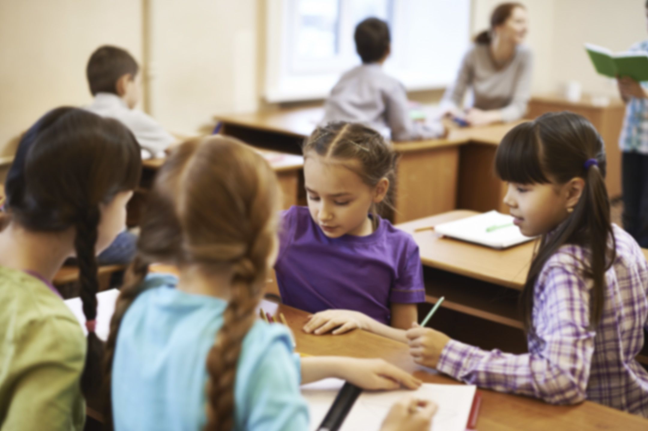 Image: girls collaborating round a table